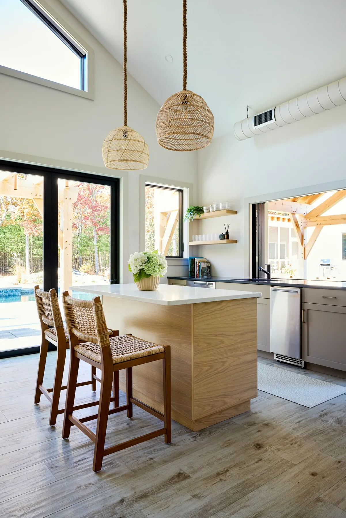 Custom pool house kitchen opening to outdoor living