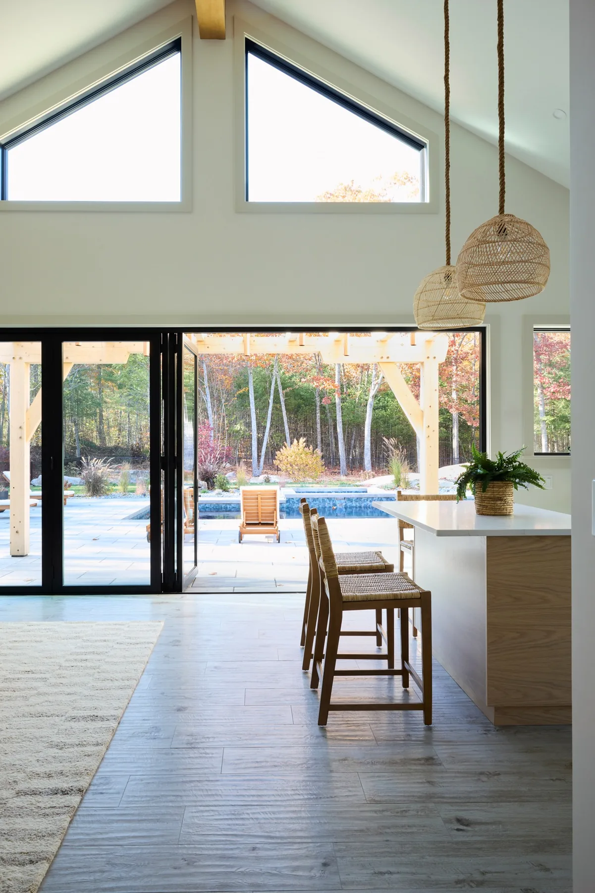 Custom York pool house opening to an outdoor living area