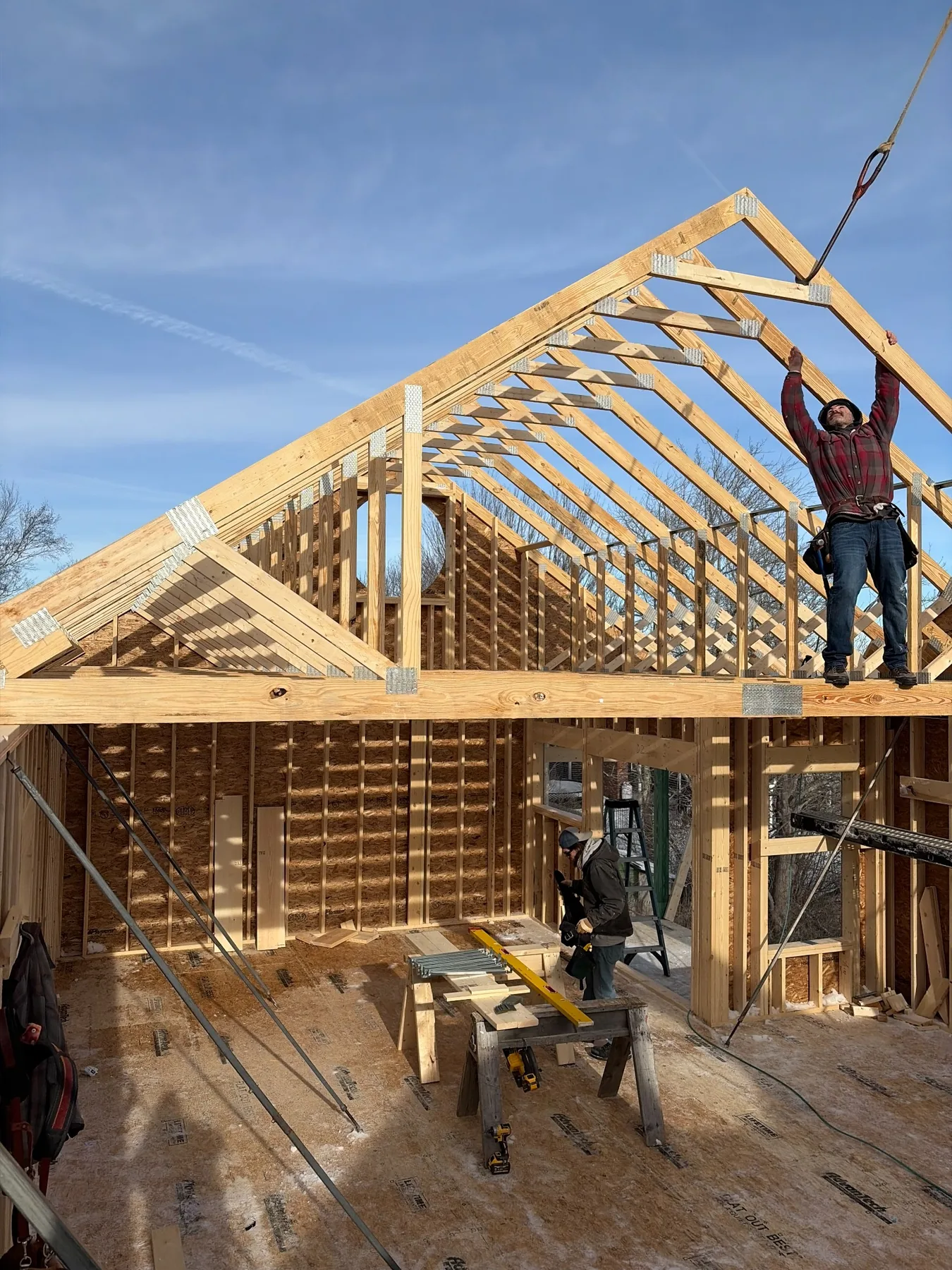Hobart carpenters setting roof trusses during framing